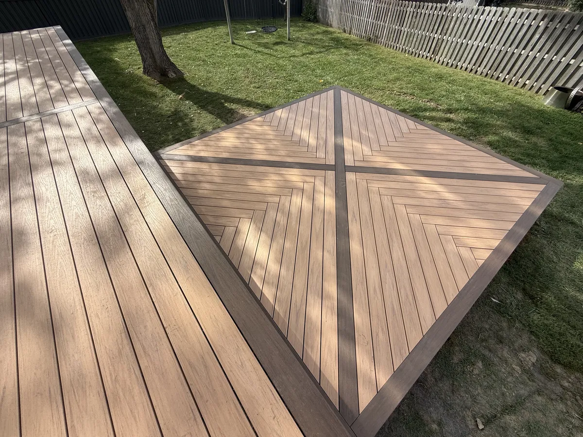 Overhead view of diagonal deck boards framed by a contrasting border