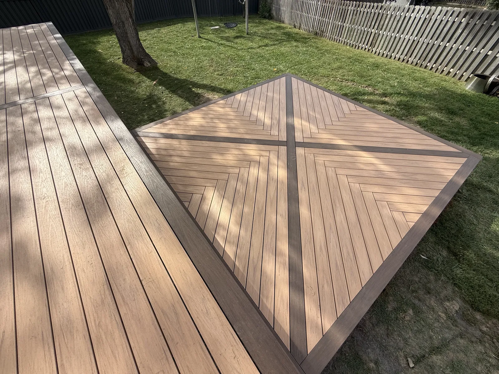 Overhead view of a deck with diagonal boards and a contrasting picture-frame border